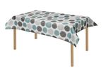 Table with a white tablecloth featuring a pattern of grey, light grey, and teal circles.