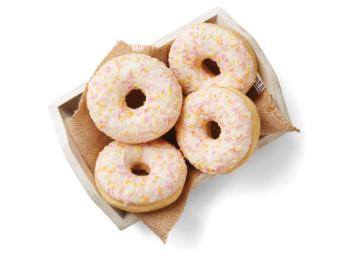 Vier donuts met roze glazuur en spikkels in een houten kistje.