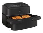 Black air fryer with a drawer pulled out, showing cooked chicken inside.