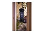 Black electric insect killer with blue light, hanging outdoors