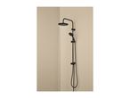 Black shower system with a large overhead shower and a handheld shower, water running.
