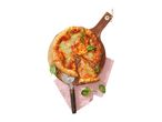 Freshly baked pizza with tomato sauce, cheese, and basil on a wooden board with a pizza cutter.
