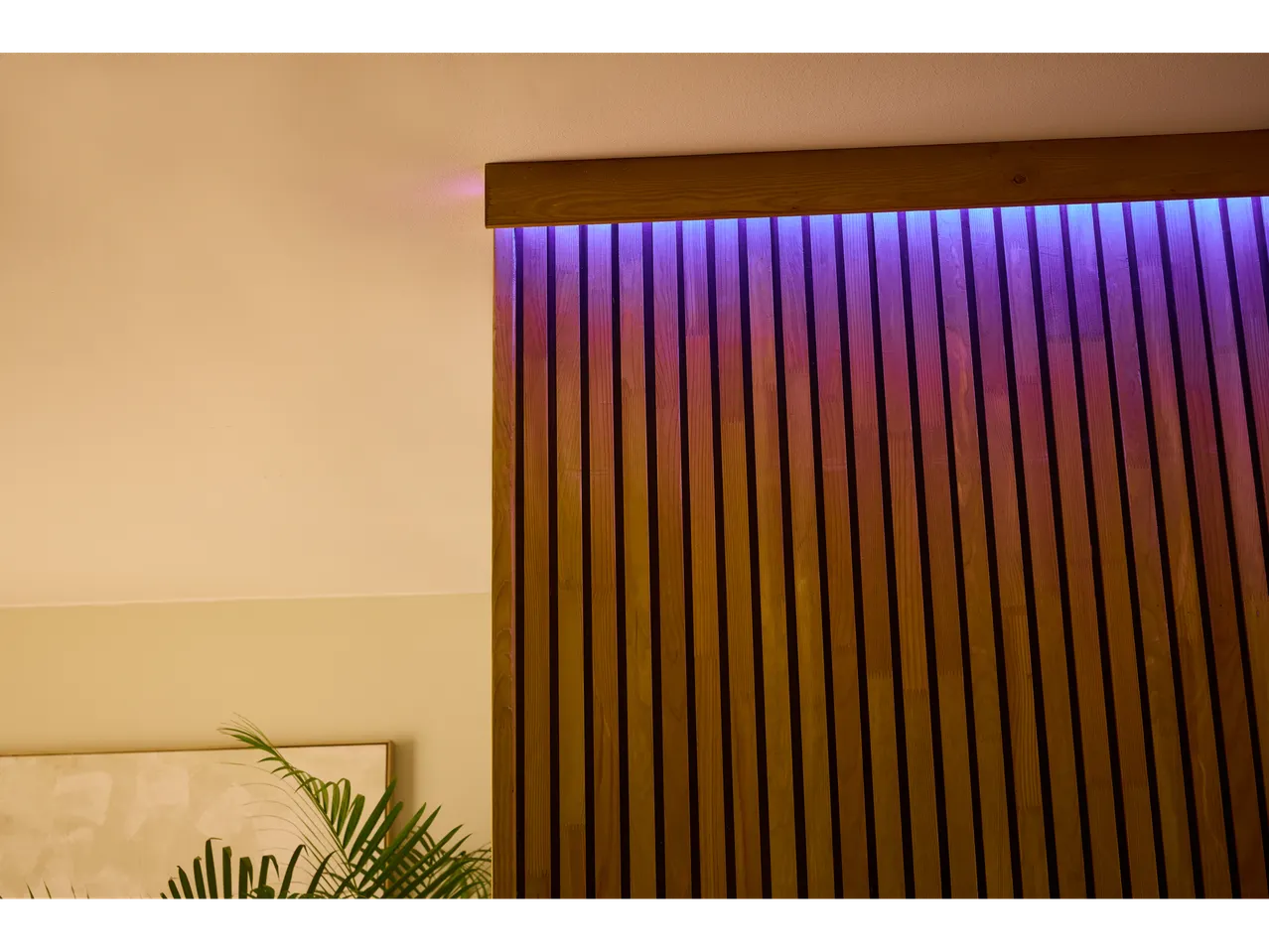 A modern wooden wall with purple LED lighting.