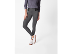 A woman in a grey sweater and grey leggings with white sneakers.