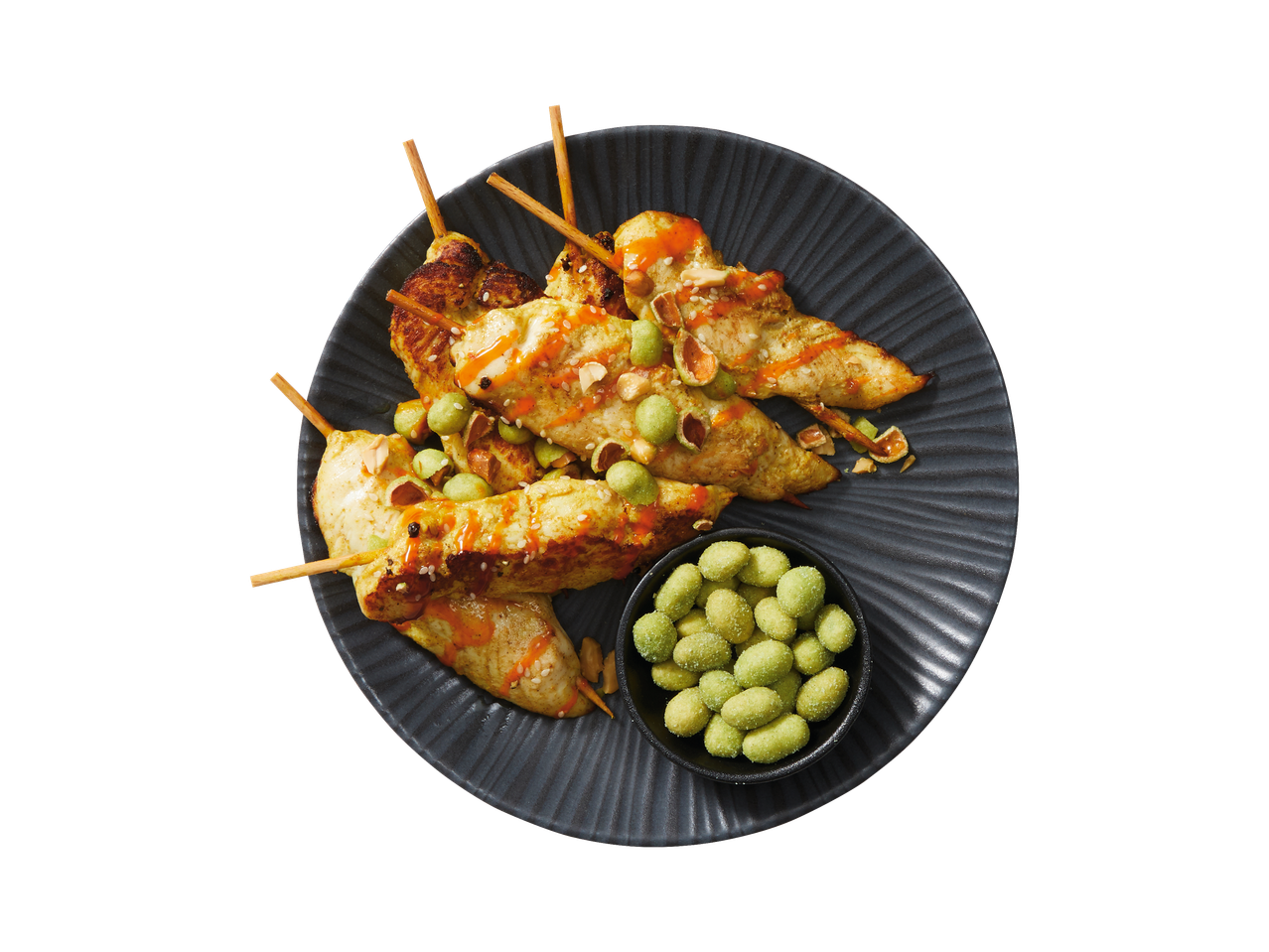 Vitasia Jordnötter wasabi en kipsatés op een donker bord.