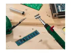 A soldering iron and electronic components like RAM and circuit boards on a wooden surface.