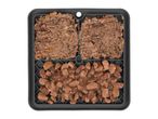 A dark grey silicone slow feeder mat holds various types of wet pet food.