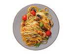 Spaghetti with shrimp, mushrooms, cherry tomatoes, and basil on a grey plate.
