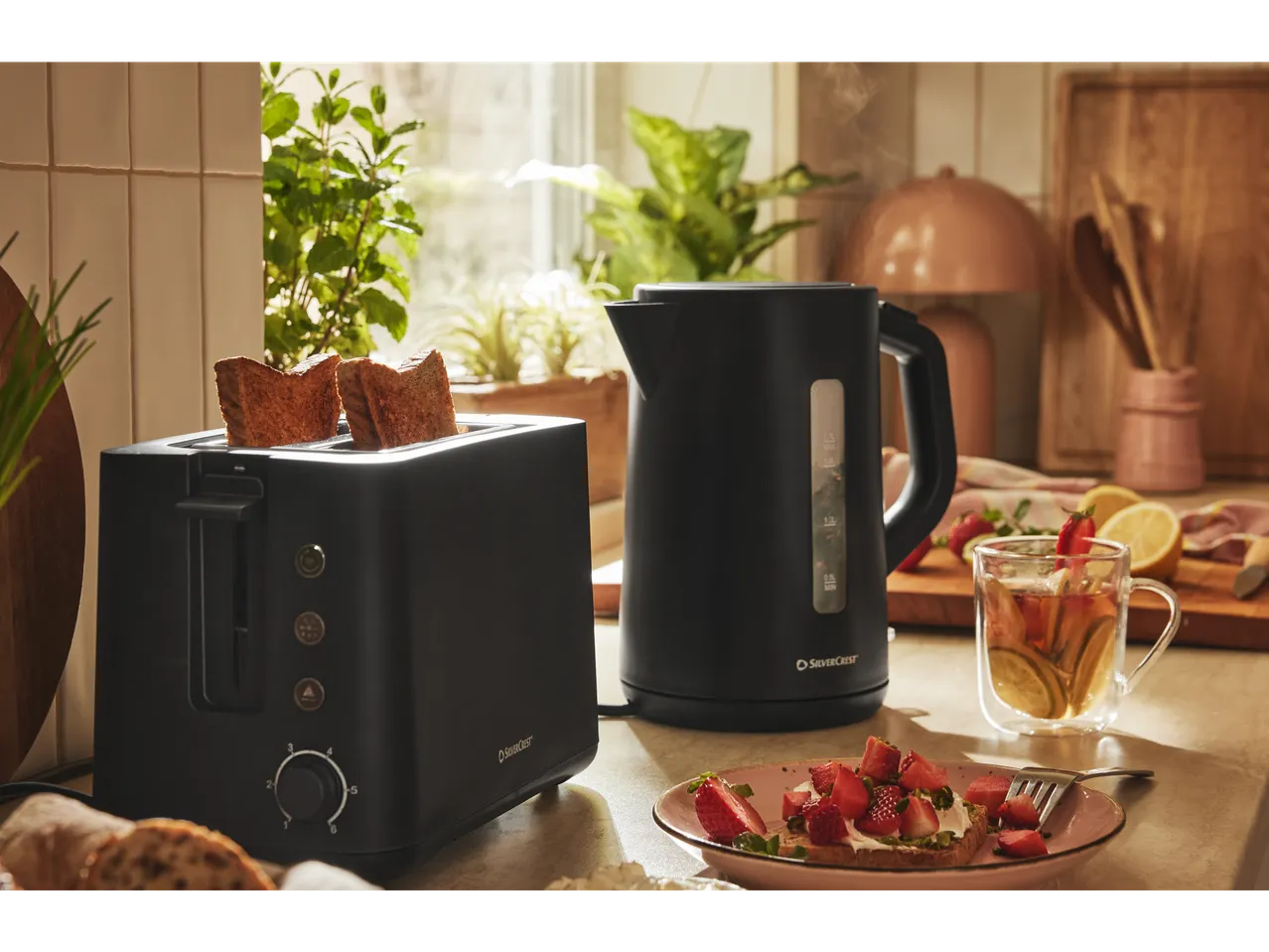 Silvercrest toaster and kettle on kitchen counter with breakfast food.