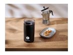 Coffee grinder with coffee beans, moka pot, and cookies on a wooden table.