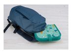Blue backpack with a teal dinosaur-themed lunch bag partially inside, on a light wooden surface.