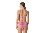 Mulher em biquíni CRIVIT com padrão zigzag rosa e azul, vista traseira