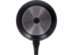 Bottom of a black frying pan with a metallic, textured base and a black handle.
