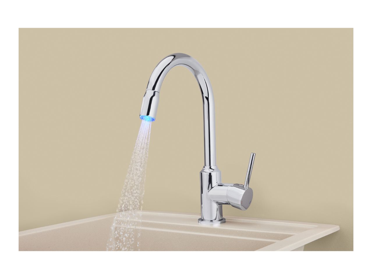 Chrome kitchen faucet with blue LED light water stream over a beige sink.