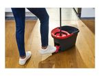 Person using a red and black mop and bucket with a foot pedal on a wooden floor.