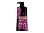Μαύρο μπουκάλι αφρόλουτρου Lux Alluring Cashmere με αντλία και ροζ τριαντάφυλλα.