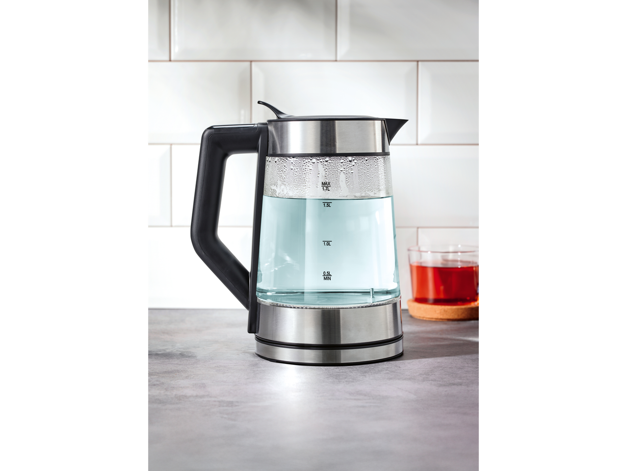 SILVERCREST® digitaalne veekeetja köögilaual, kõrval klaas teed