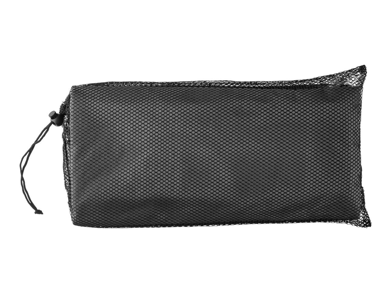 Black mesh bag containing a yoga mat.
