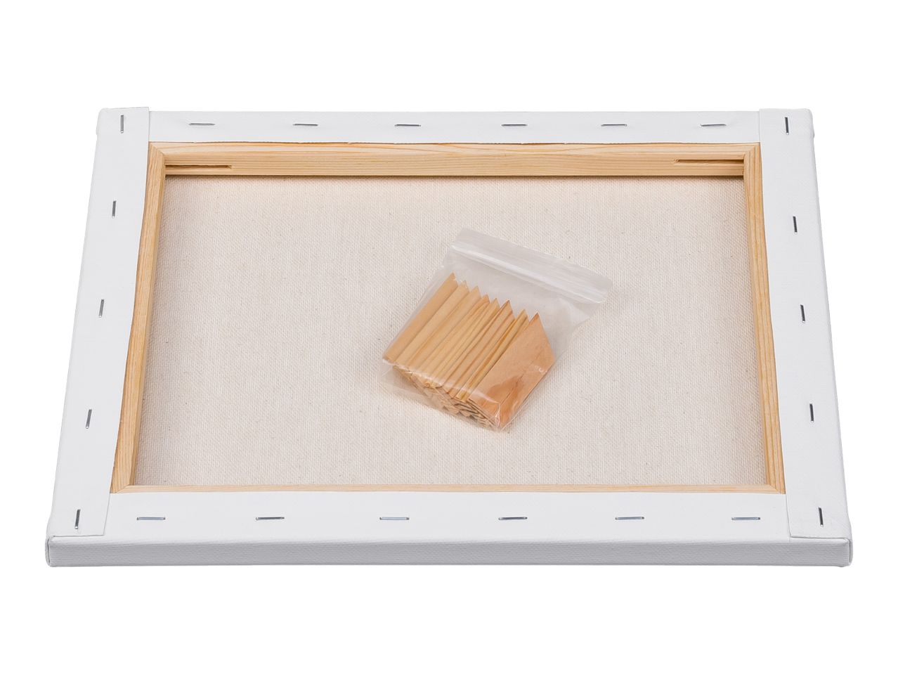 Back of a stretched canvas with a wooden frame and a small bag of wooden wedges.