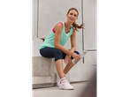 Woman in Crivit sportswear: tank top, leggings, and sneakers.