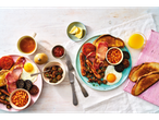 A delicious full Irish breakfast with fried eggs, bacon, sausages, baked beans, and toast.