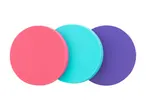 Three round, colorful fitness sliders in pink, teal, and purple.