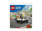 Toy go-kart racer set with a minifigure, on a race track background.