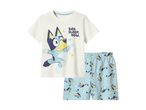 Kids' cream short-sleeved pajama set with a blue dog character and 'BED. SLEEP. NOW.' text.