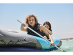 Two women paddle an inflatable Aclam kayak.