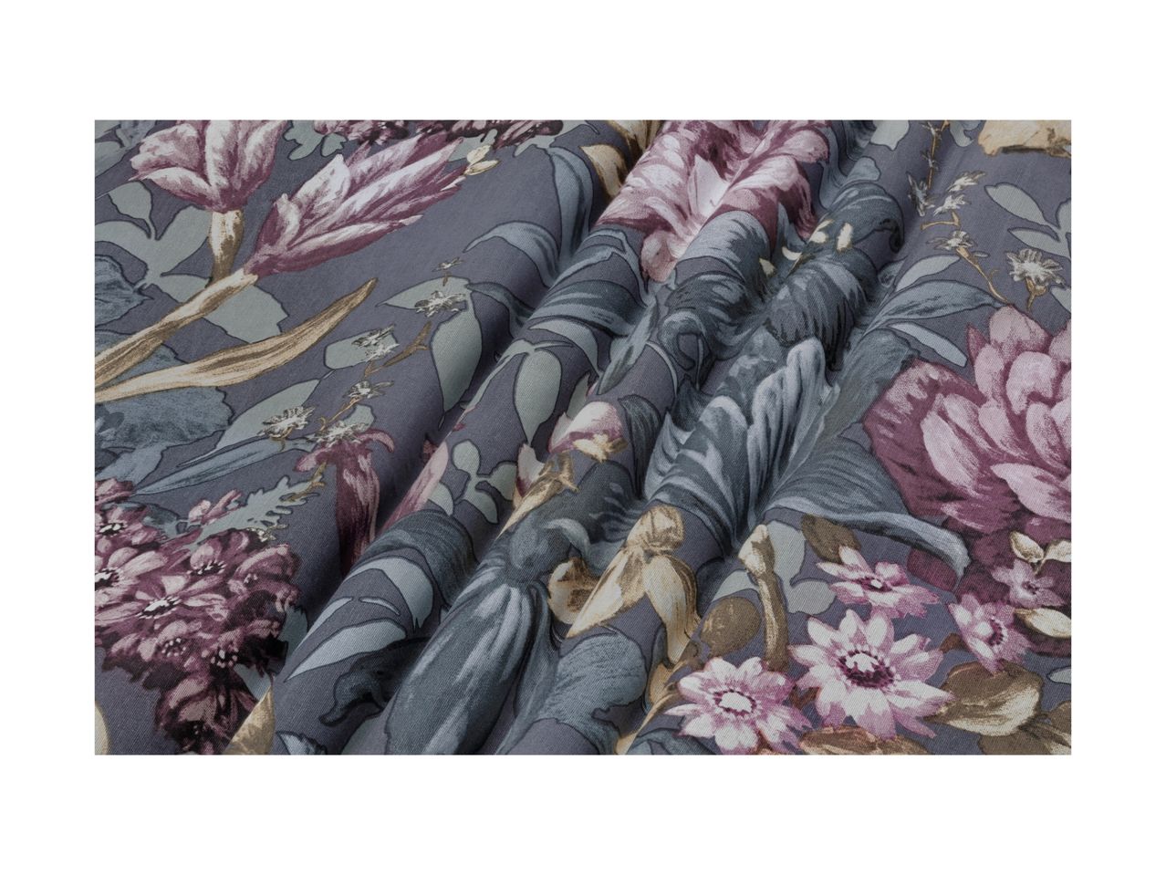 Floral patterned fabric in shades of purple, grey, and green, with visible folds.