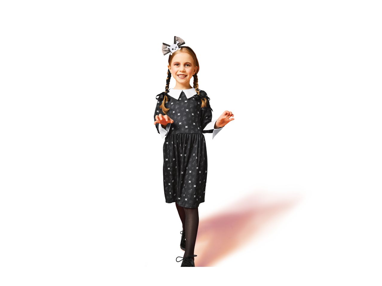 A young girl in a Wednesday Addams-style dress with a skull bow in her hair.