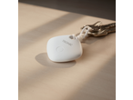 White Tronic® Smart Tag Finder with keys on a wooden table.
