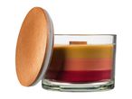 A layered candle in a glass jar with a wooden lid, featuring shades of yellow, orange, and red.