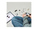 Child building a toy car with building blocks, following instructions on a tablet.