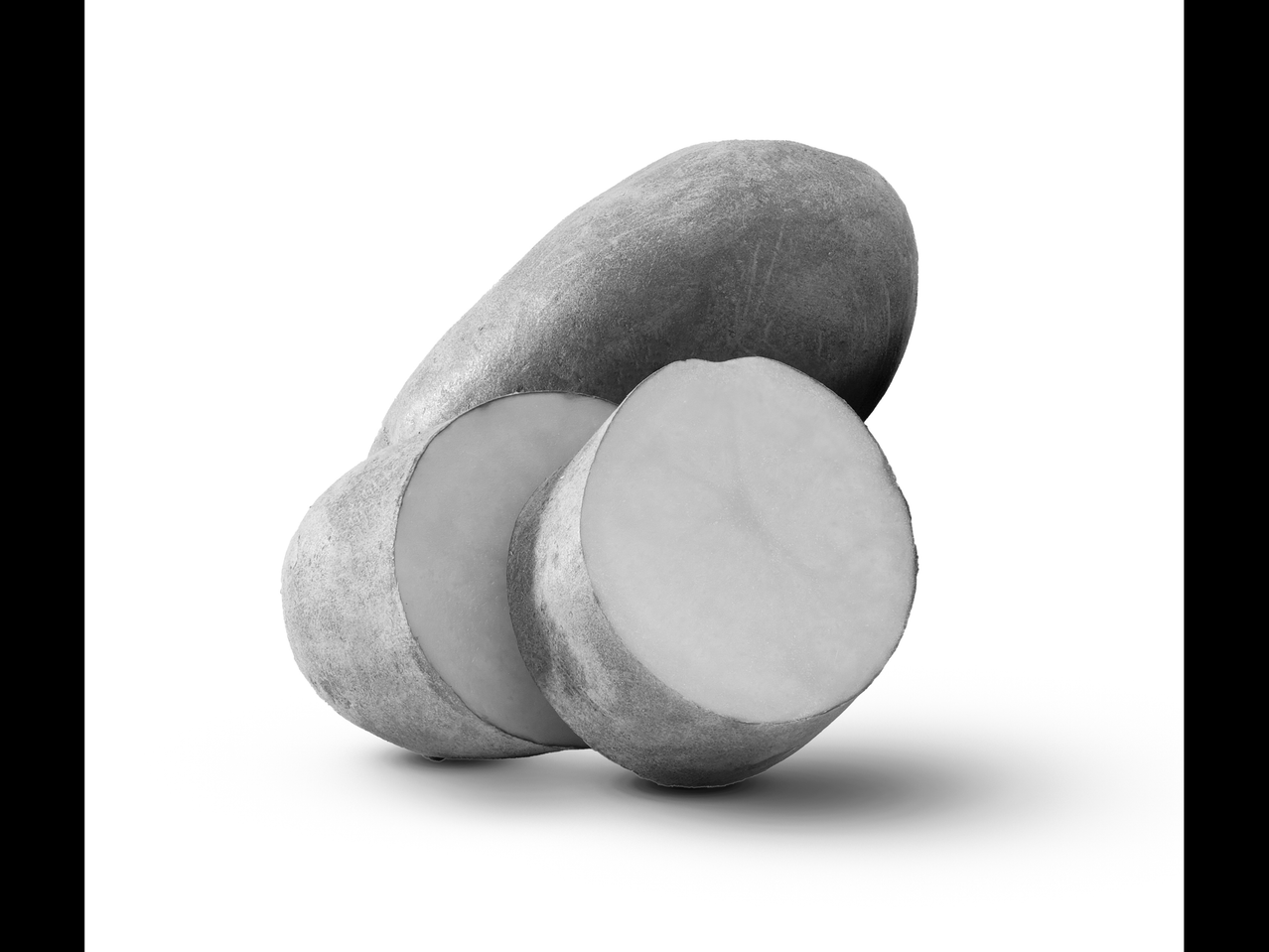 A whole potato and two sliced potato pieces on a white background.