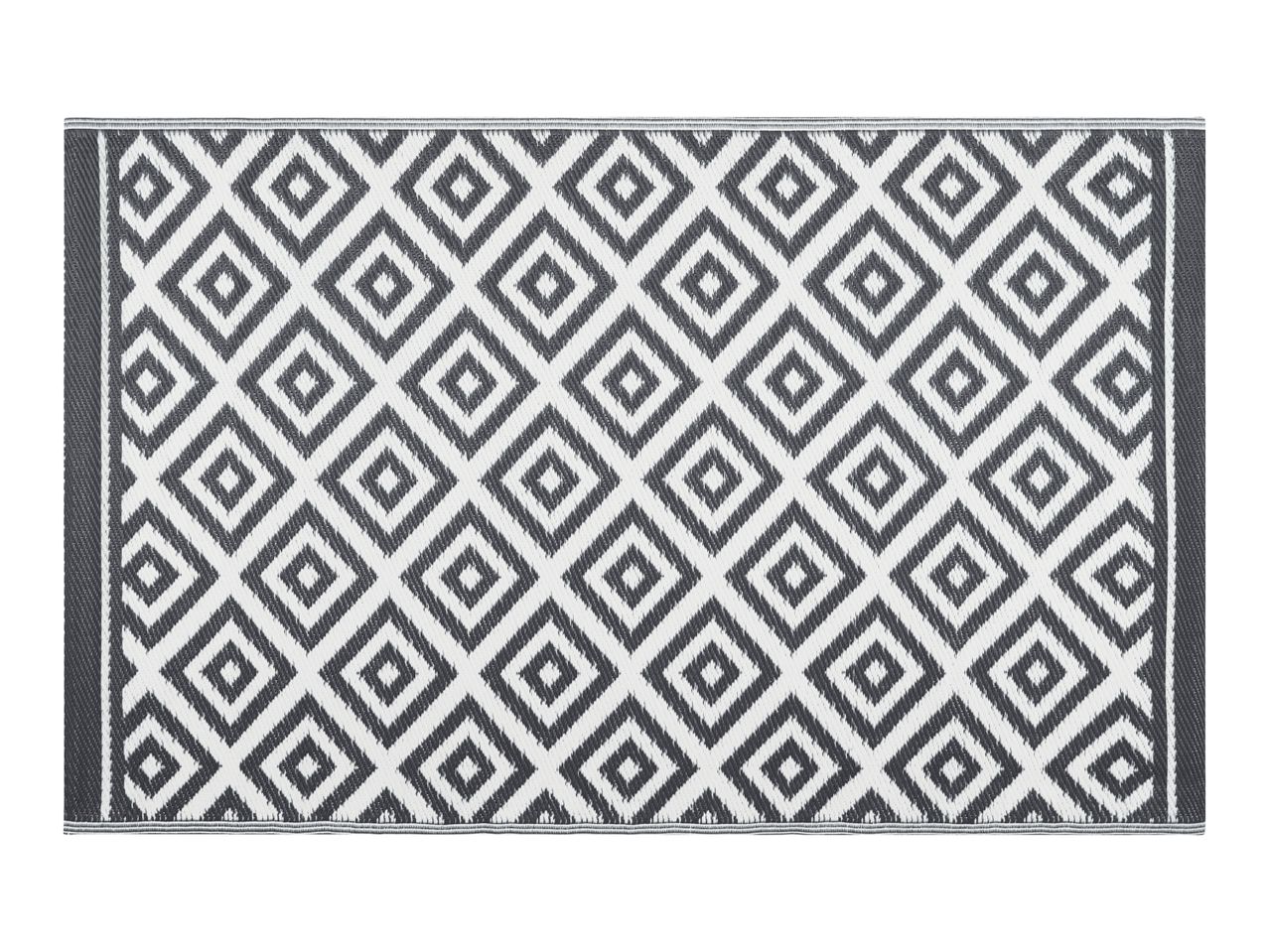 Grey and white outdoor rug with a geometric diamond pattern
