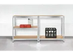 Two metal shelving units with beige shelves hold a toolbox, a plastic canister, and a crate of bottled water against a white brick wall.