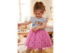 A toddler girl wears a pink Paw Patrol tulle dress.
