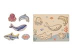 Wooden sea animal puzzle with octopus, dolphin, whale, shark, and crab pieces.