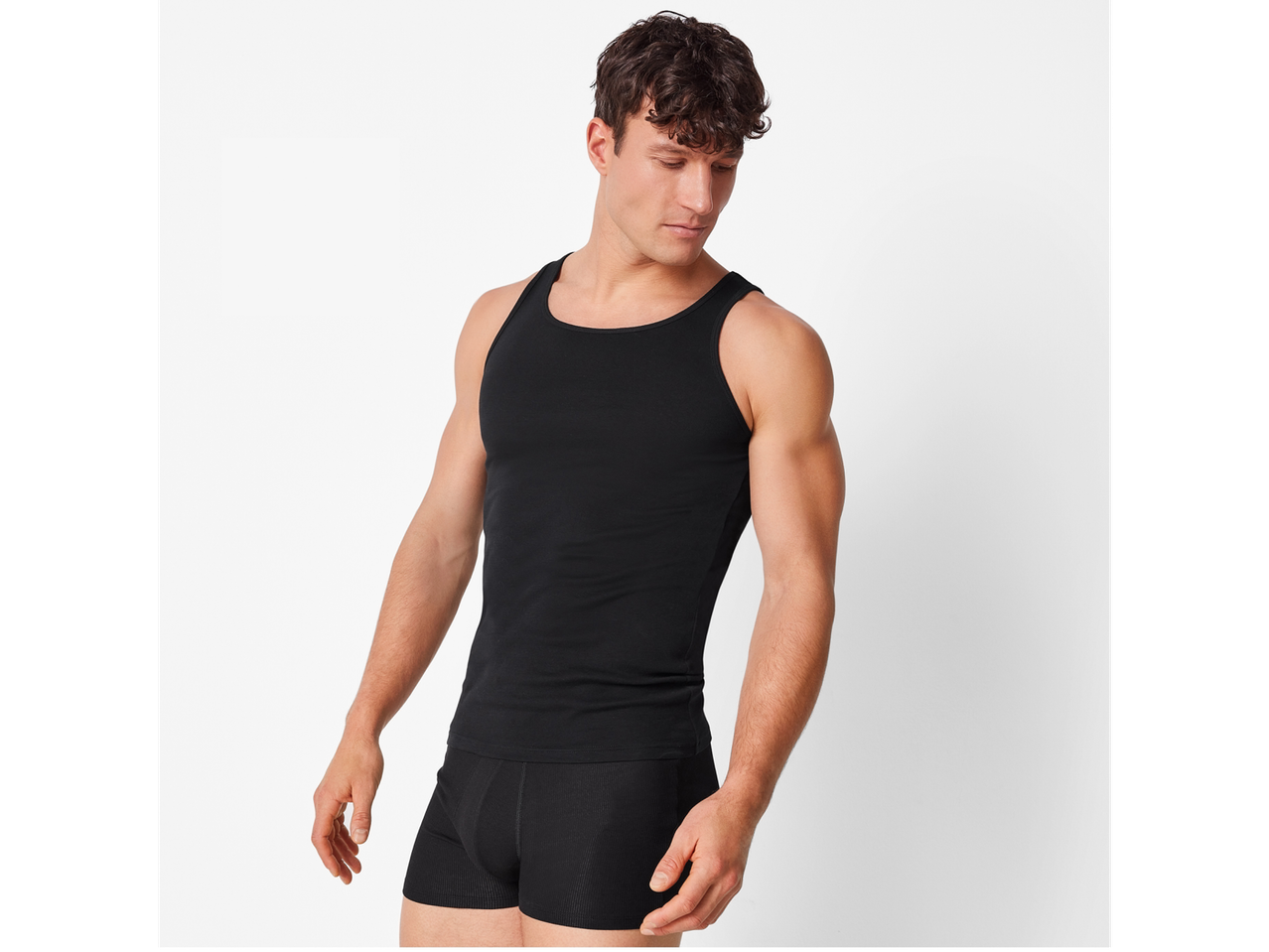 A man in a black tank top and black boxer briefs.