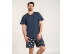 Man in a dark blue short-sleeved pajama top and lemon-patterned shorts