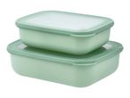 Two stacked rectangular food storage containers with light green bases and translucent lids.
