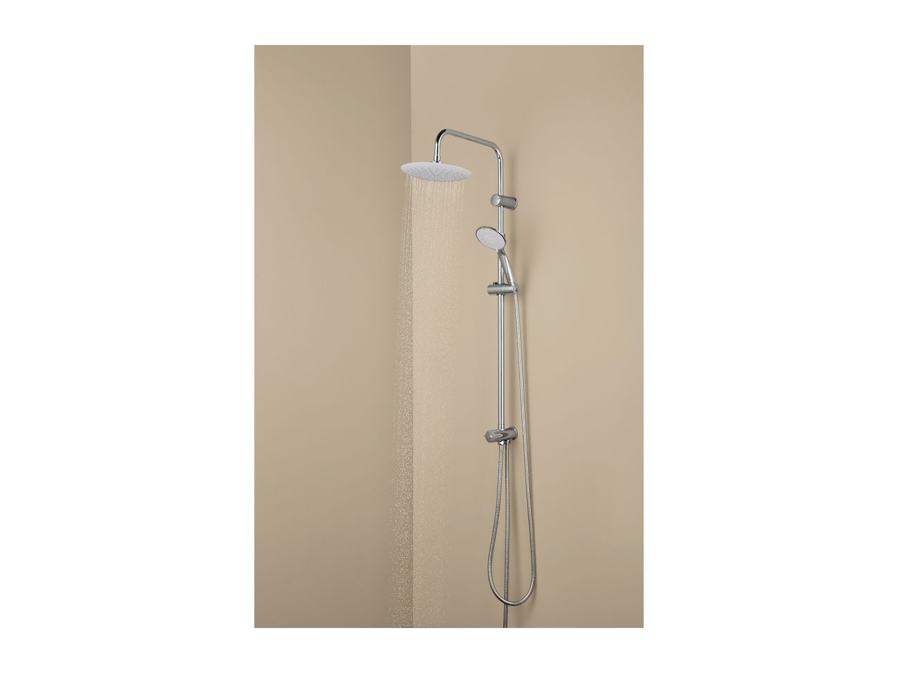 Chrome shower system with a large overhead shower and a handheld shower, water running.