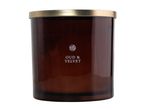 Oud & Velvet scented candle in a brown glass jar with a gold lid