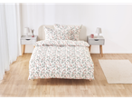 A bed with a floral duvet cover and matching pillowcases sits in a bedroom.