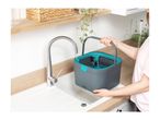 A person filling a grey and teal cleaning bucket with water from a kitchen faucet.