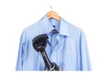 Handheld garment steamer being used on a light blue shirt hanging on a wooden hanger.