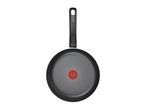 Black frying pan with a red heat indicator in the center, viewed from above.