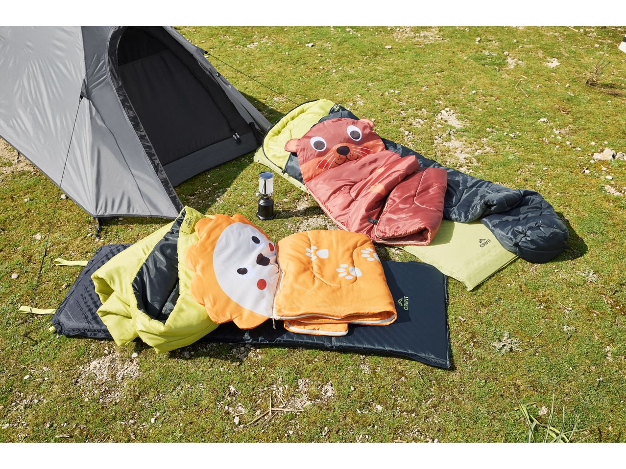 Kids’ Sleeping Bag on a garden, near a tent
