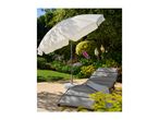 Garden lounger with grey cushions and a white parasol on a patio.